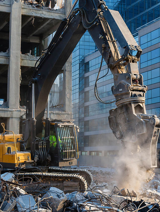 Excavator demolition a building