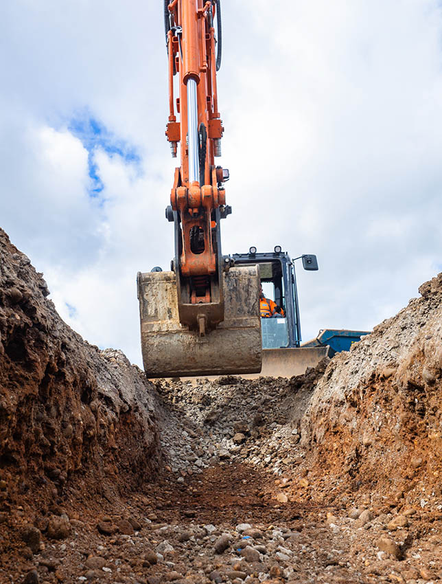 Hydraulic Excavator digging a trench for building foundations